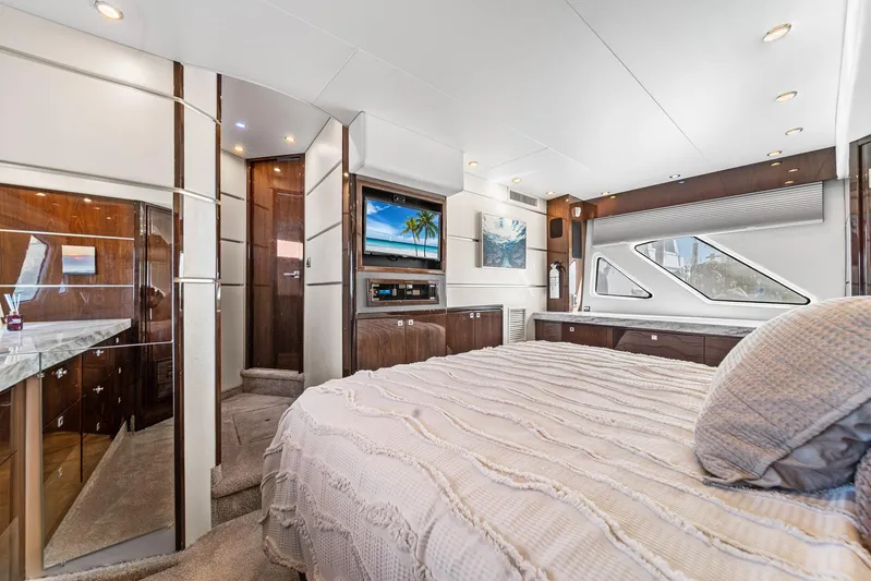Sunline Yacht Photos Pics Luxurious interior of a 2007 Marquis 55 LS yacht bedroom with modern amenities.