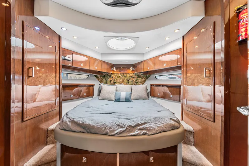 Sunline Yacht Photos Pics Luxurious 2007 Marquis 55 LS yacht bedroom with elegant wood paneling and plush bedding.