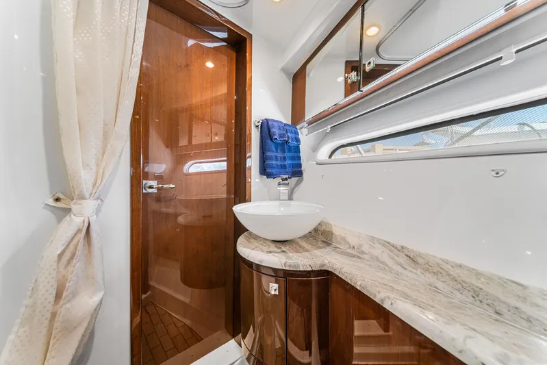 Sunline Yacht Photos Pics Luxurious bathroom in 2007 Marquis 55 LS yacht with elegant wood and marble finishes.