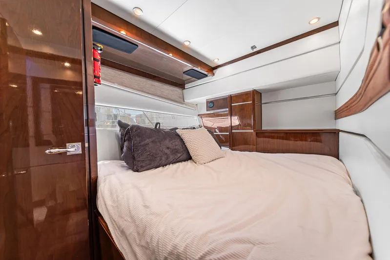 Sunline Yacht Photos Pics Luxurious bedroom interior of 2007 Marquis 55 LS yacht with elegant wood finishes.