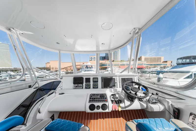 Sunline Yacht Photos Pics Helm of 2007 Marquis 55 LS yacht with modern controls and panoramic marina view.