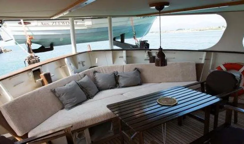Zeewoelf Yacht Photos Pics Luxurious 1963 Custom Mr. de Boot yacht interior with cozy seating and elegant wooden table.
