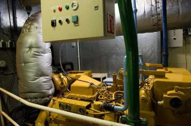 Zeewoelf Yacht Photos Pics Engine room with yellow machinery, control panel, and insulated pipes, Custom mr. de Boot 1963.