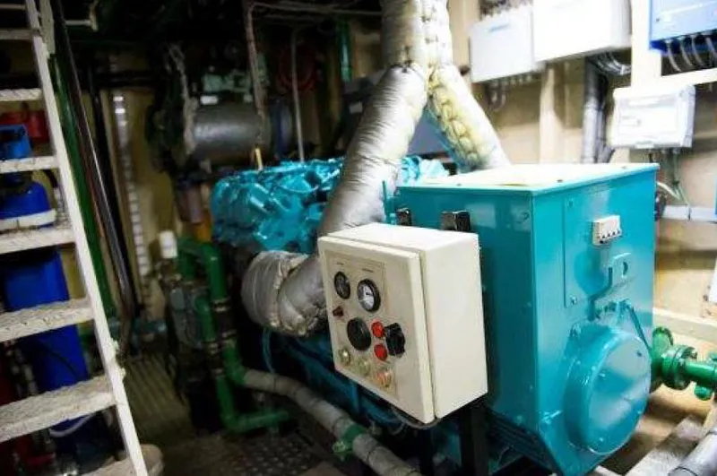 Zeewoelf Yacht Photos Pics Engine room with a vintage 1963 Custom mr. de Boot machinery, featuring control panel and pipes.