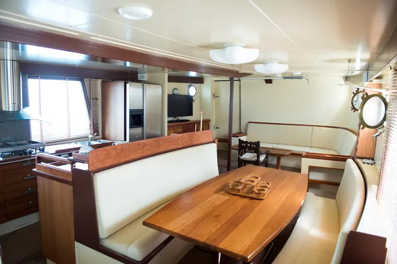 Zeewoelf Yacht Photos Pics Luxurious 1963 custom yacht interior with wooden dining area and modern kitchen.