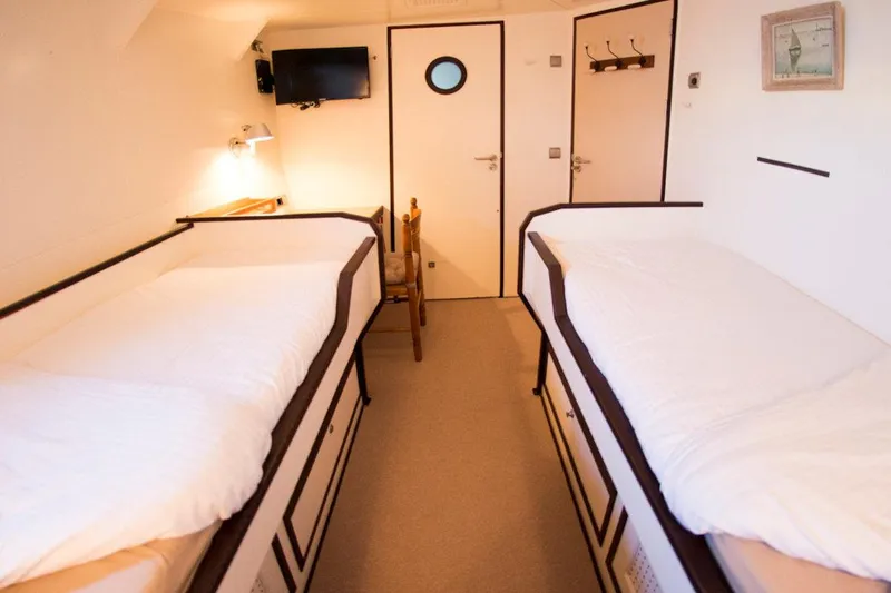 Zeewoelf Yacht Photos Pics Two cozy beds in a 1963 Custom Mr. de Boot cabin with nautical decor.