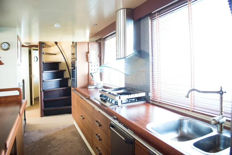 Zeewoelf Yacht Photos Pics Luxurious kitchen interior on a 1963 Custom Mr. de Boot yacht, featuring modern appliances and wooden finishes.