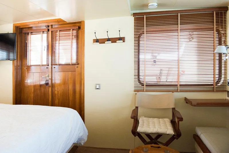 Zeewoelf Yacht Photos Pics Cozy 1963 custom boat cabin with wooden decor, bed, and window blinds.