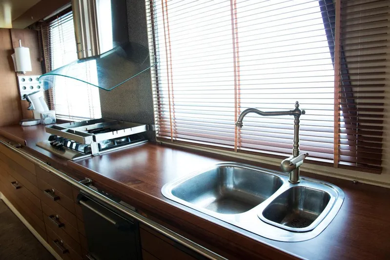 Zeewoelf Yacht Photos Pics Modern kitchen with stainless steel sink, wooden countertops, and blinds. Custom "mr. de Boot" 1963.