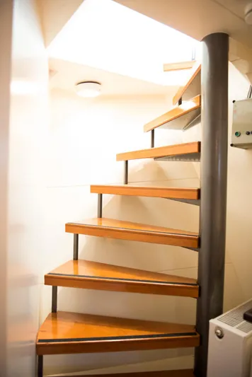 Zeewoelf Yacht Photos Pics Wooden spiral staircase in a 1963 Custom mr. de Boot model interior.