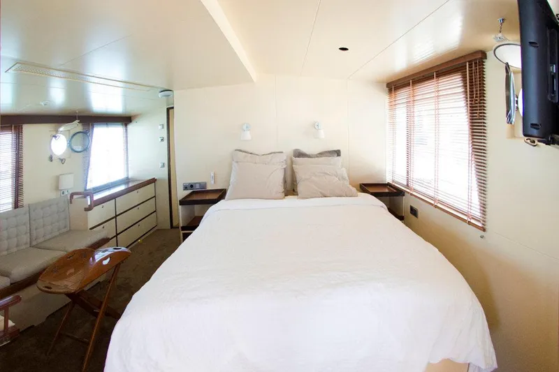 Zeewoelf Yacht Photos Pics Cozy bedroom interior on 1963 Custom Mr. de Boot yacht with bed and wooden blinds.
