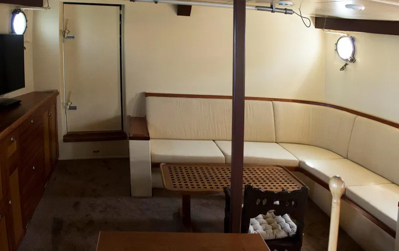 Zeewoelf Yacht Photos Pics Interior of 1963 Custom Mr. de Boot yacht with beige seating and wooden accents.