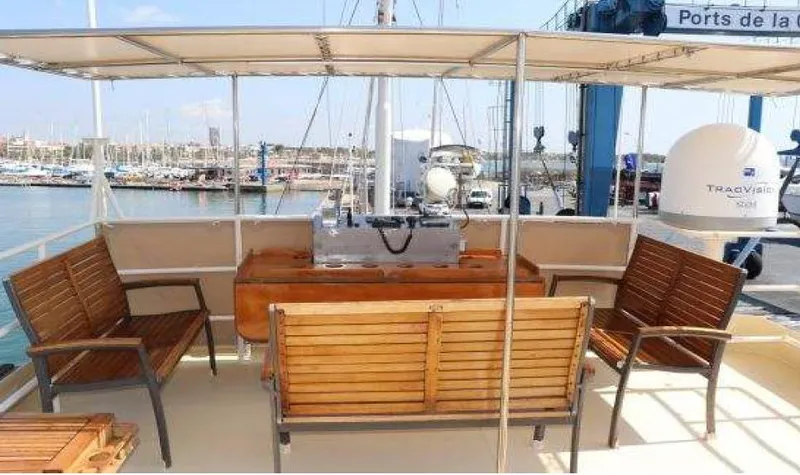 Zeewoelf Yacht Photos Pics Vintage 1963 Custom Mr. de Boot yacht deck with wooden seating and marina view.