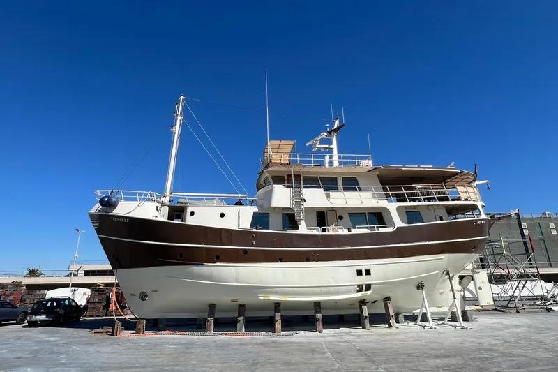 Zeewoelf Yacht Photos Pics Custom 1963 "mr. de Boot" yacht on dry dock under clear blue sky.