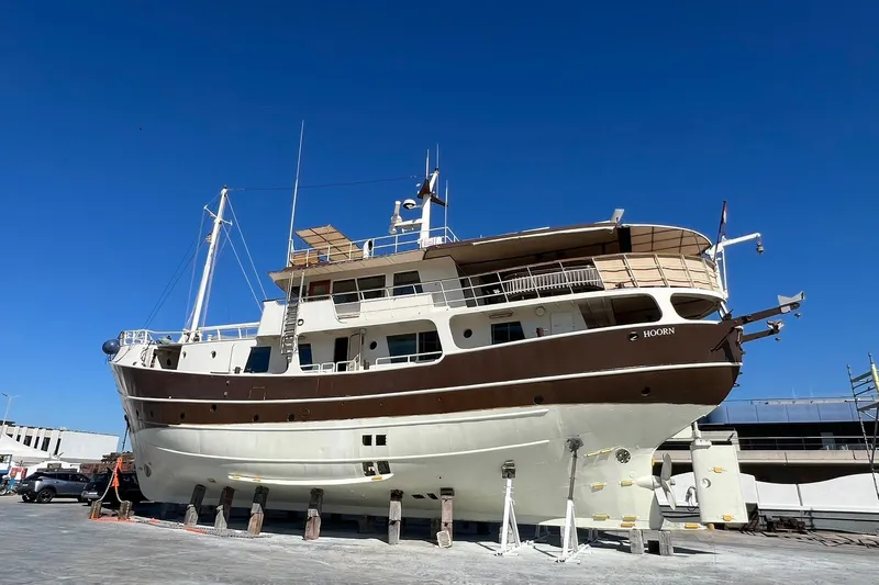 Zeewoelf Yacht Photos Pics Custom 1963 "mr. de Boot" yacht on dry dock under clear blue sky.