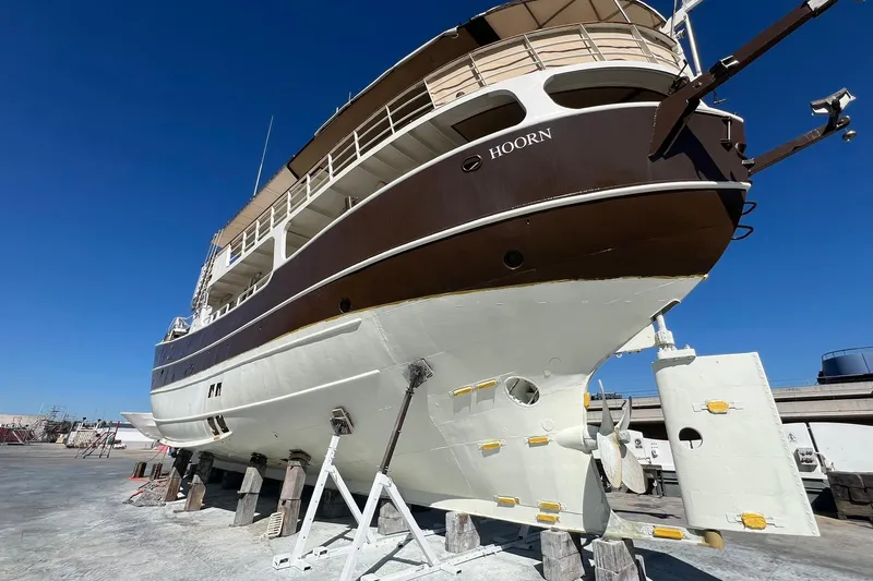 Zeewoelf Yacht Photos Pics Custom 1963 "mr. de Boot" yacht on dry dock, named "Hoorn," under clear blue sky.
