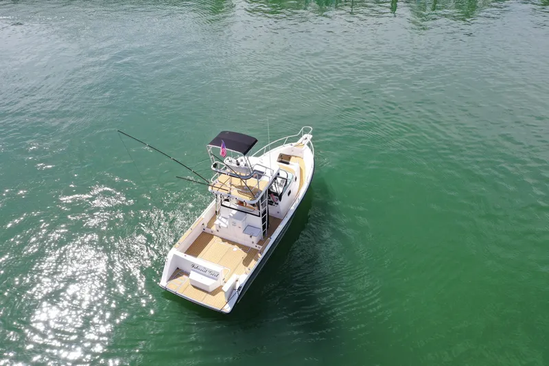 Island Girl Yacht Photos Pics 1992 Luhrs 300 Tournament boat on calm green water, aerial view.