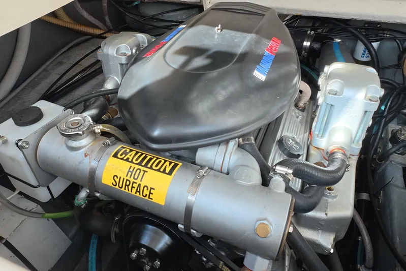 Island Girl Yacht Photos Pics Engine compartment of a 1992 Luhrs 300 Tournament boat with caution label.