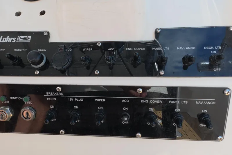 Island Girl Yacht Photos Pics Control panel of a 1992 Luhrs 300 Tournament boat with various switches and labels.