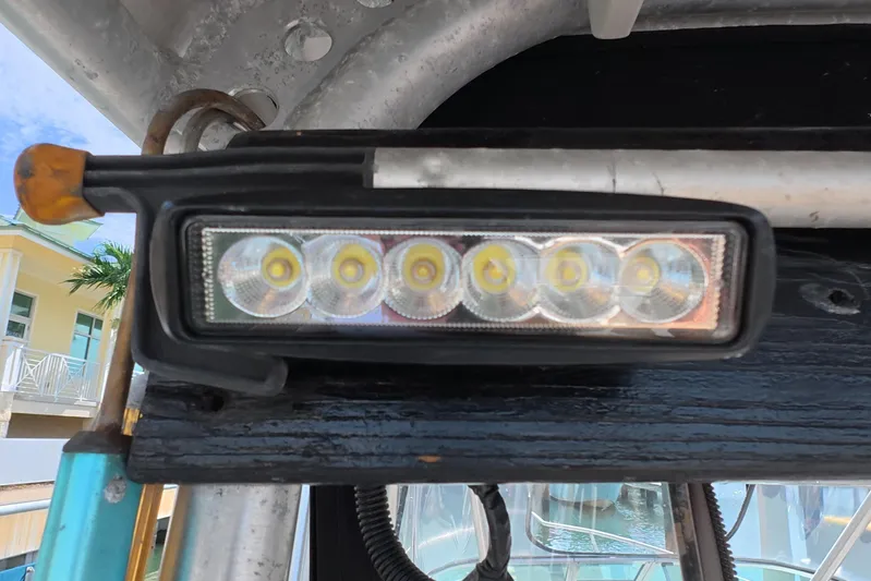 Island Girl Yacht Photos Pics Close-up of LED light on 1992 Luhrs 300 Tournament boat, docked near a building.