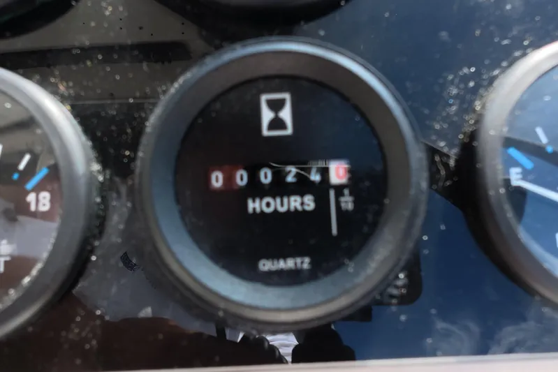 Island Girl Yacht Photos Pics Hour meter showing 240 hours on 1992 Luhrs 300 Tournament boat dashboard.