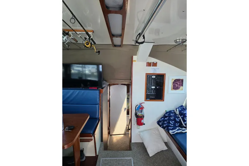  Yacht Photos Pics Interior of 2000 JM Custom 42 boat with seating, TV, and safety equipment.
