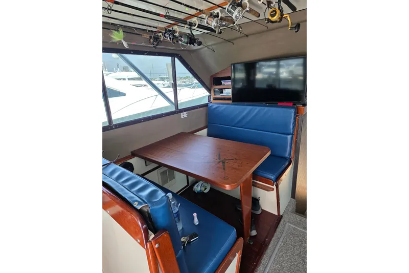  Yacht Photos Pics Interior of 2000 JM Custom 42 boat with blue seating and fishing rods.