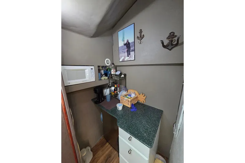  Yacht Photos Pics Small kitchen area in a 2000 JM Custom 42 boat with microwave and countertop essentials.