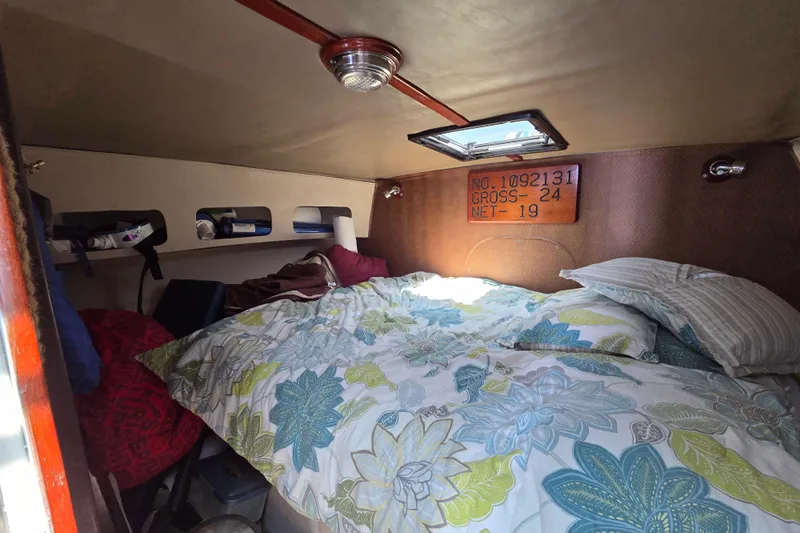  Yacht Photos Pics Cozy cabin interior of 2000 JM Custom 42 sailboat with floral bedding and natural light.