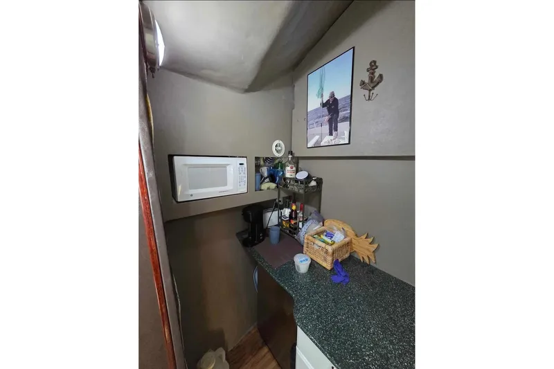  Yacht Photos Pics Compact kitchen area in a 2000 JM Custom 42 boat with microwave and countertop essentials.