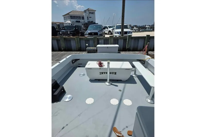  Yacht Photos Pics 2000 JM Custom 42 boat docked, featuring spacious deck and storage, with marina in background.