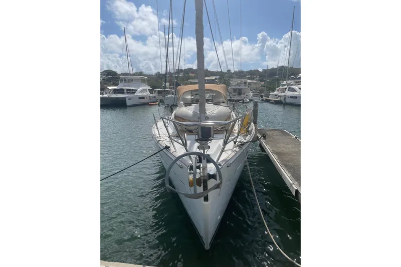 Kasoumai Yacht Photos Pics 2007 Beneteau 423 sailboat docked in a marina under a partly cloudy sky.
