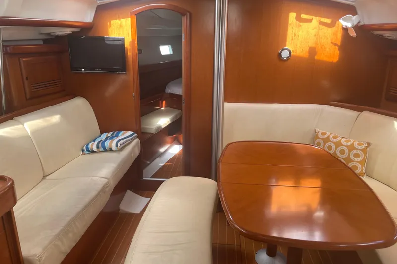 Kasoumai Yacht Photos Pics Interior of 2007 Beneteau 423 yacht with cozy seating and wooden table.