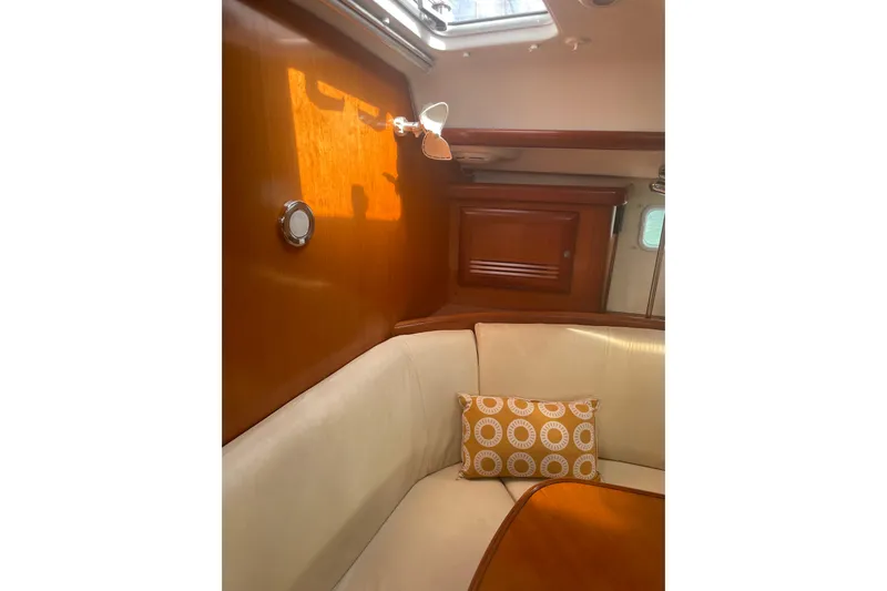Kasoumai Yacht Photos Pics Interior of 2007 Beneteau 423 yacht with wooden paneling and cushioned seating.