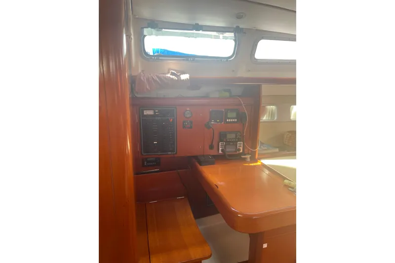 Kasoumai Yacht Photos Pics Interior of 2007 Beneteau 423 sailboat with navigation equipment and wooden finish.