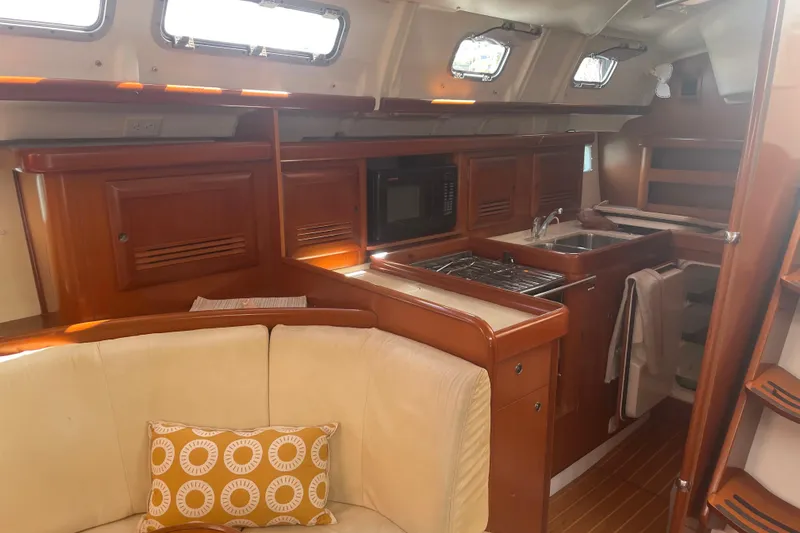 Kasoumai Yacht Photos Pics Interior of 2007 Beneteau 423 yacht with kitchen and seating area.