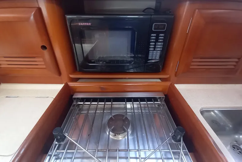 Kasoumai Yacht Photos Pics Galley kitchen in 2007 Beneteau 423 with microwave and stove.