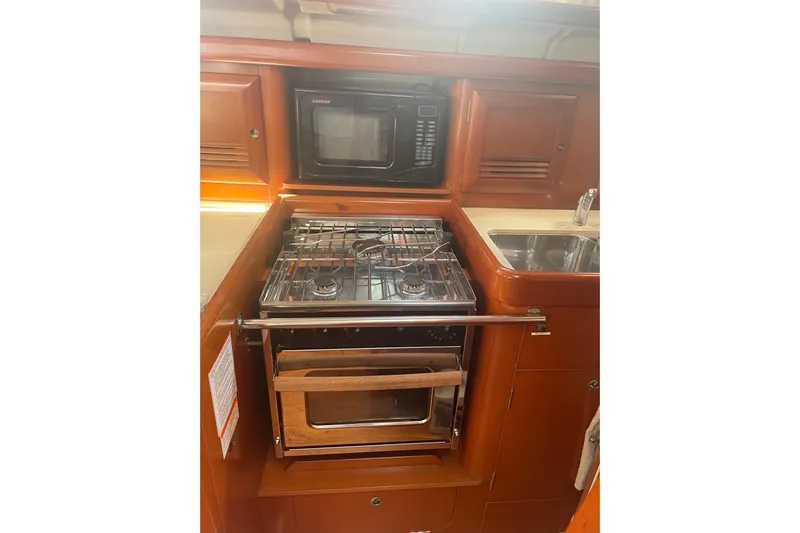 Kasoumai Yacht Photos Pics Galley kitchen in 2007 Beneteau 423 yacht with stove, oven, and microwave.