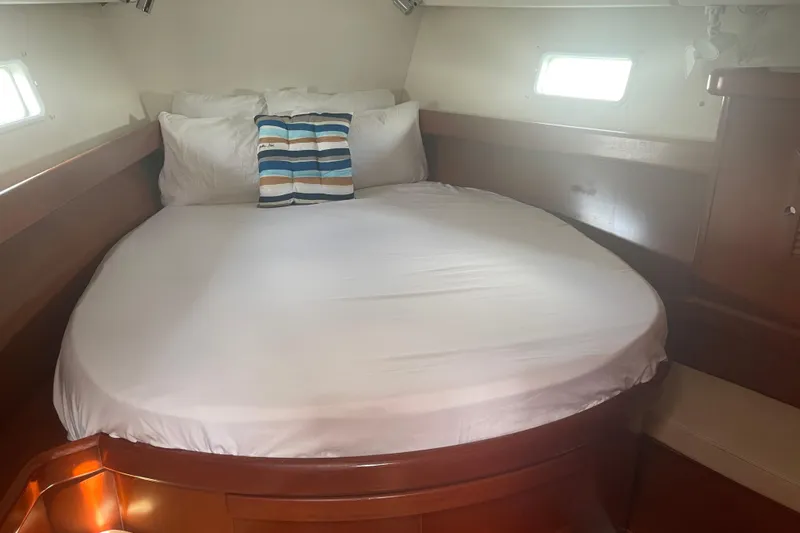 Kasoumai Yacht Photos Pics Cozy cabin interior of 2007 Beneteau 423 yacht with comfortable bed and striped pillow.