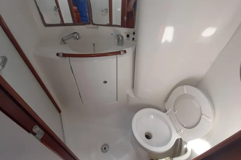Kasoumai Yacht Photos Pics 2007 Beneteau 423 yacht bathroom with sink, mirror, and toilet.