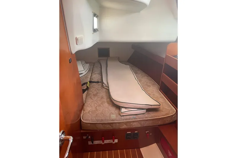 Kasoumai Yacht Photos Pics Interior cabin of 2007 Beneteau 423 sailboat with mattress and wooden shelving.