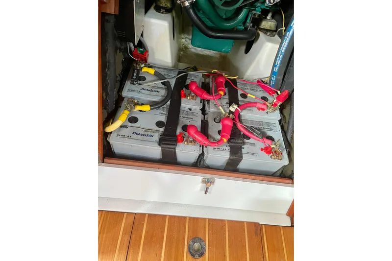 Kasoumai Yacht Photos Pics Battery compartment of a 2007 Beneteau 423 sailboat, showing multiple connected batteries.