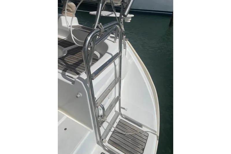 Kasoumai Yacht Photos Pics Stainless steel ladder on 2007 Beneteau 423 yacht, docked by the water.