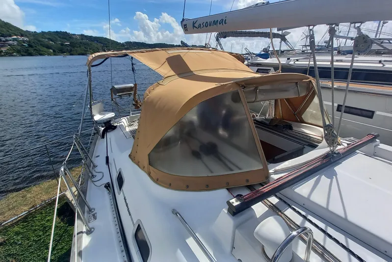 Kasoumai Yacht Photos Pics 2007 Beneteau 423 sailboat with tan canopy docked by scenic waterfront.