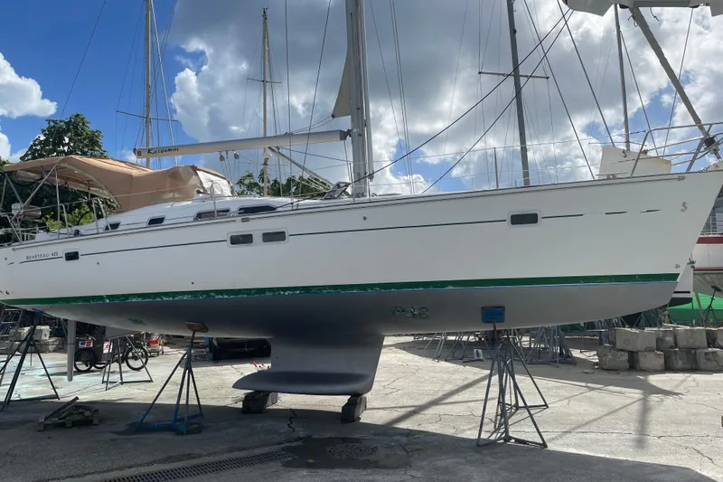 Kasoumai Yacht Photos Pics 2007 Beneteau 423 sailboat on stands, under a cloudy sky in a boatyard.