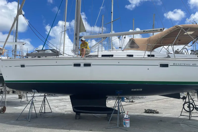 Kasoumai Yacht Photos Pics 2007 Beneteau 423 sailboat on dry dock with person sitting on deck.