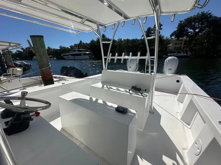  Yacht Photos Pics 2025 AmeraCat 395 boat interior with steering wheel and seating, docked by the water.