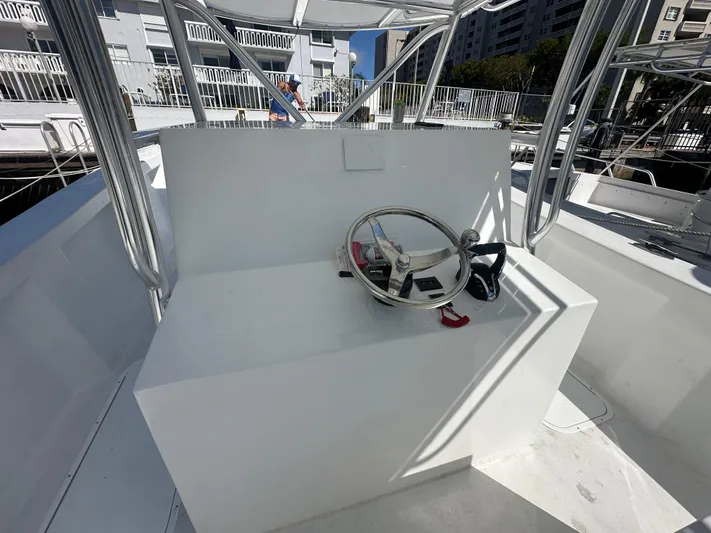  Yacht Photos Pics 2025 AmeraCat 395 boat helm with steering wheel and controls, docked in a marina.