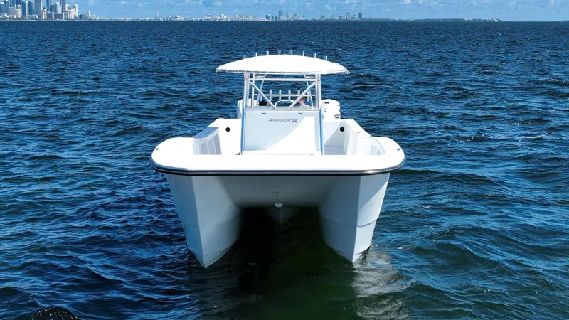  Yacht Photos Pics 2025 AmeraCat 395 catamaran on open water with city skyline in background.