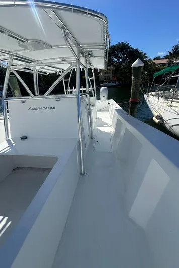  Yacht Photos Pics 2025 AmeraCat 395 boat, sleek design, docked under clear blue sky.